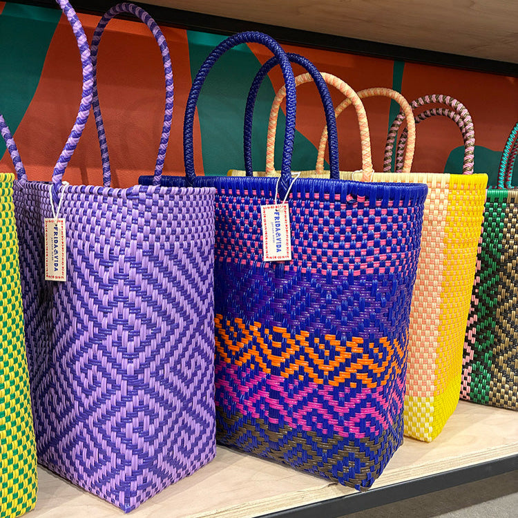 Vibrant, handwoven bags in bold patterns and colors, crafted by artisans using traditional techniques that reflect the lively spirit of global craftsmanship.
